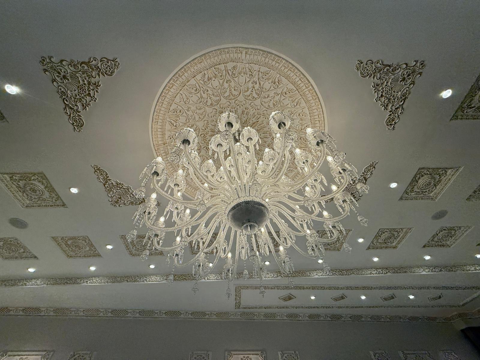 Crystal chandelier and carved ceiling at Darbar Rooftop Banquet Hall, Lahore