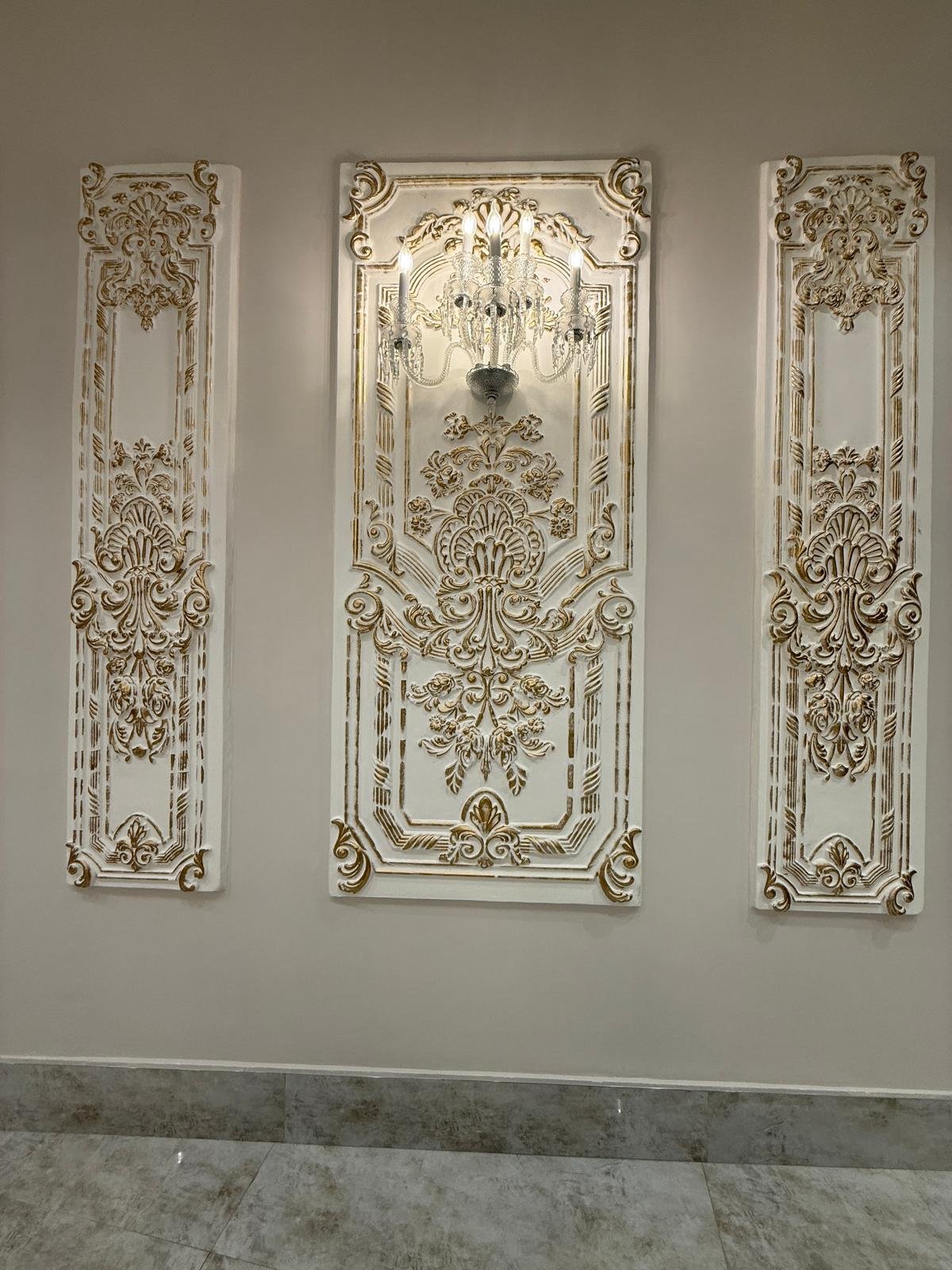 Carved white and gold wall panels inside Darbar Rooftop Banquet Hall